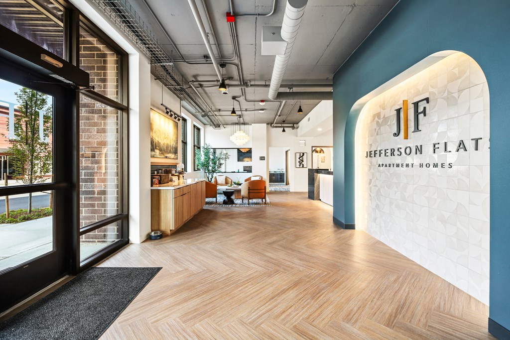 a lobby with a reception desk and a glass door