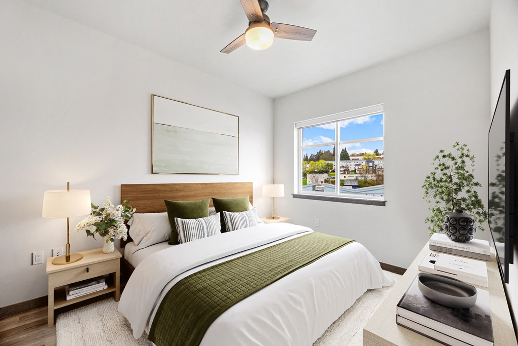 a bedroom with a large bed and a ceiling fan