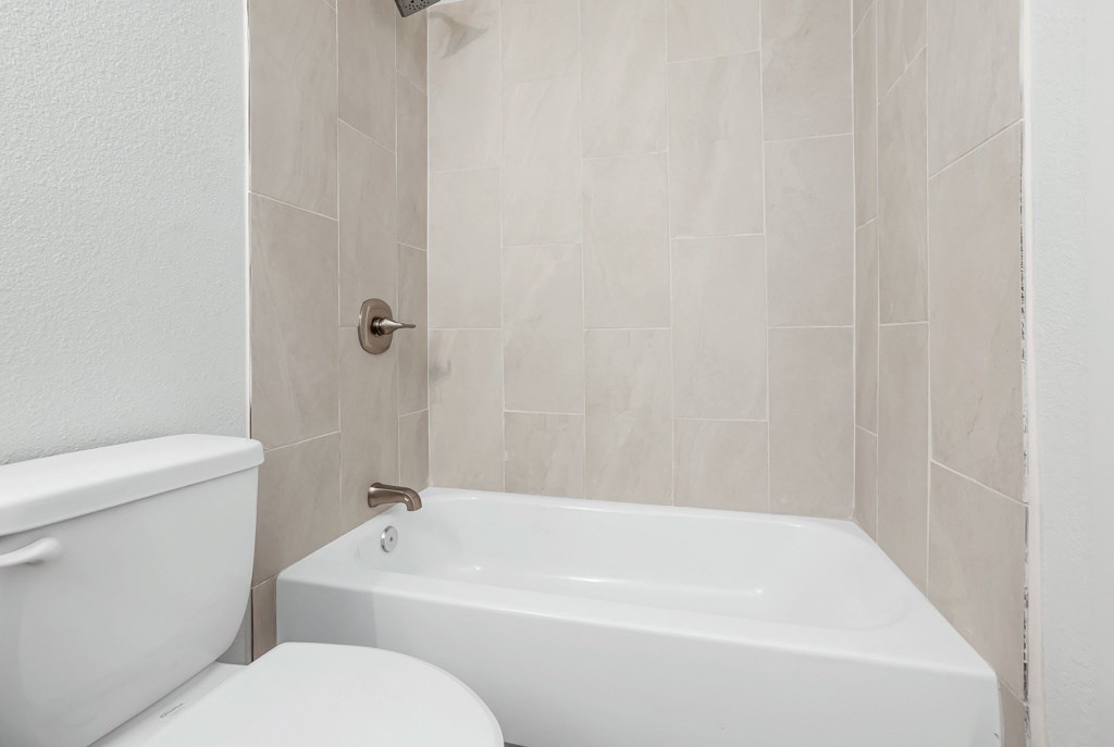 a bathroom with a toilet and a bathtub