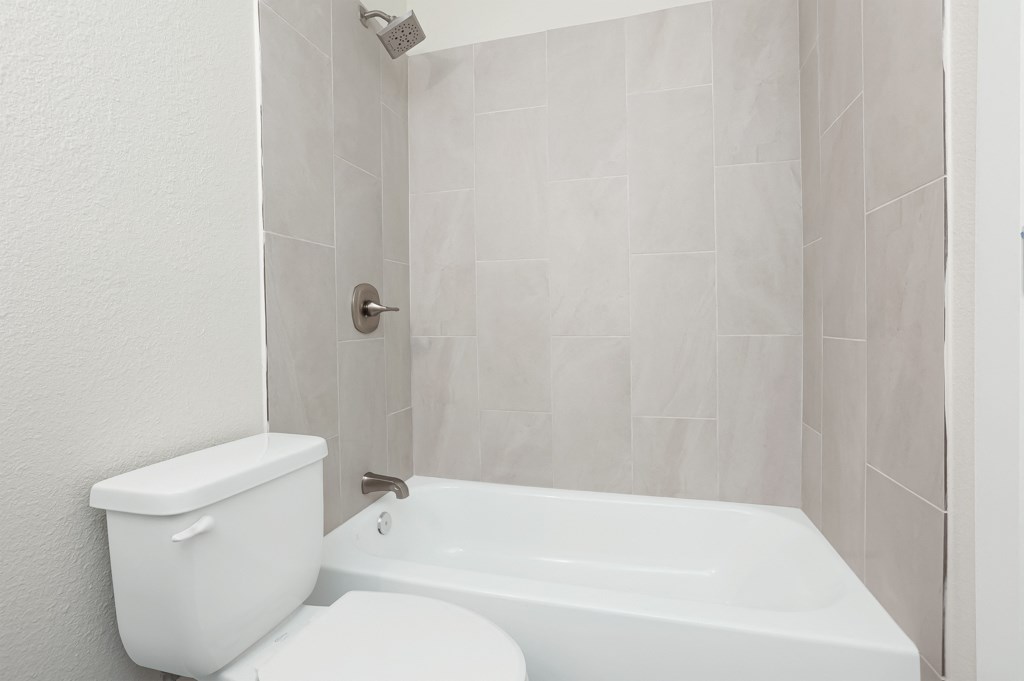 a bathroom with a toilet and a bathtub