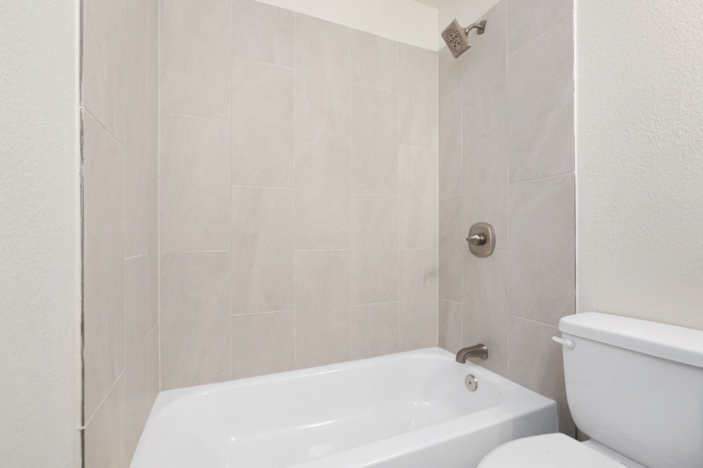 a bathroom with a toilet and a bathtub