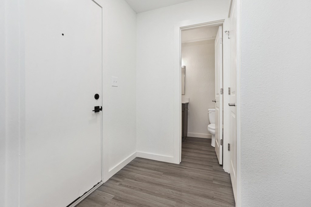 a bedroom in a 555 waverly unit with a door to a bathroom