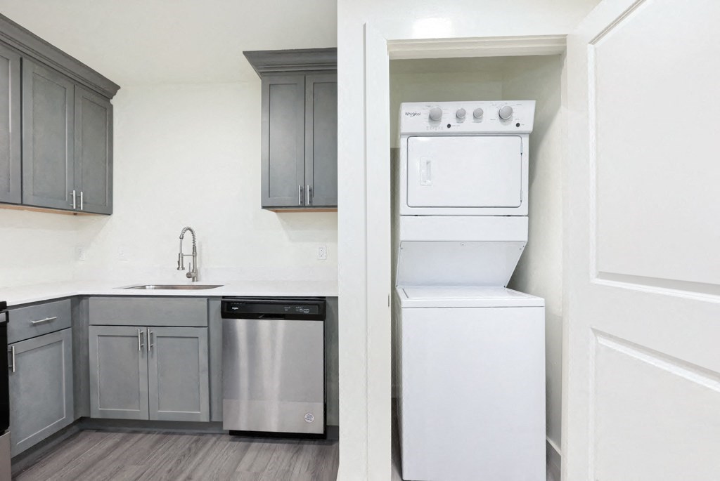a kitchen with gray cabinets and white appliances