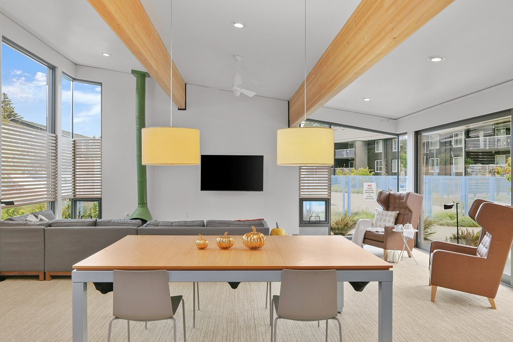 a living room with a table and chairs and a television