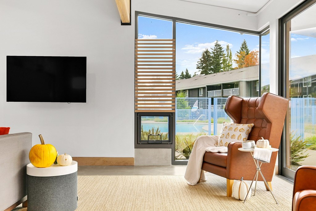 a living room with a large window and a television