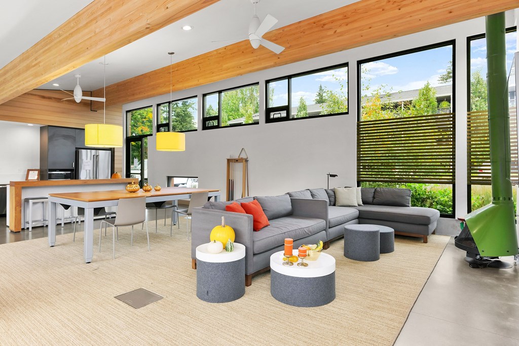 a living room with a gray couch and a table with chairs