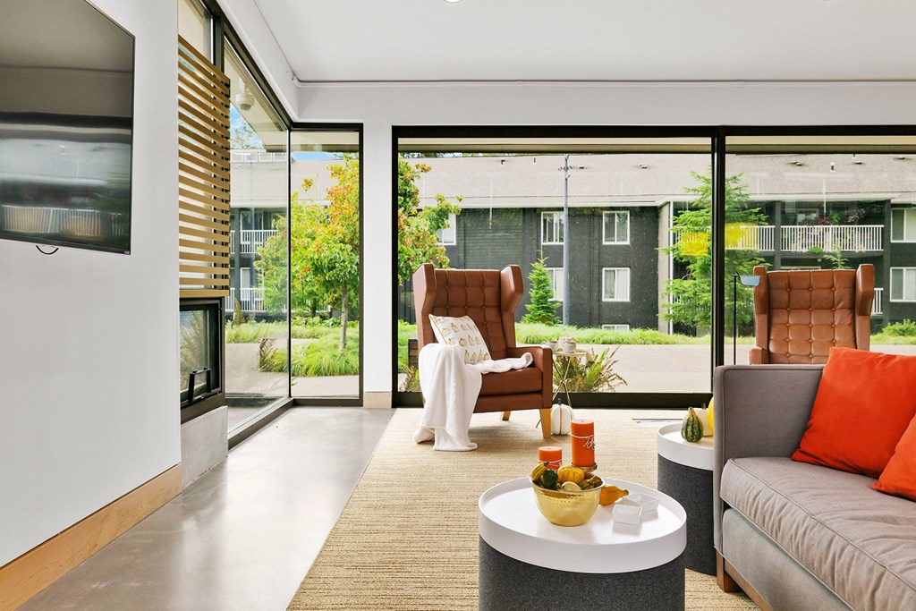 a living room with a couch and chairs and a coffee table