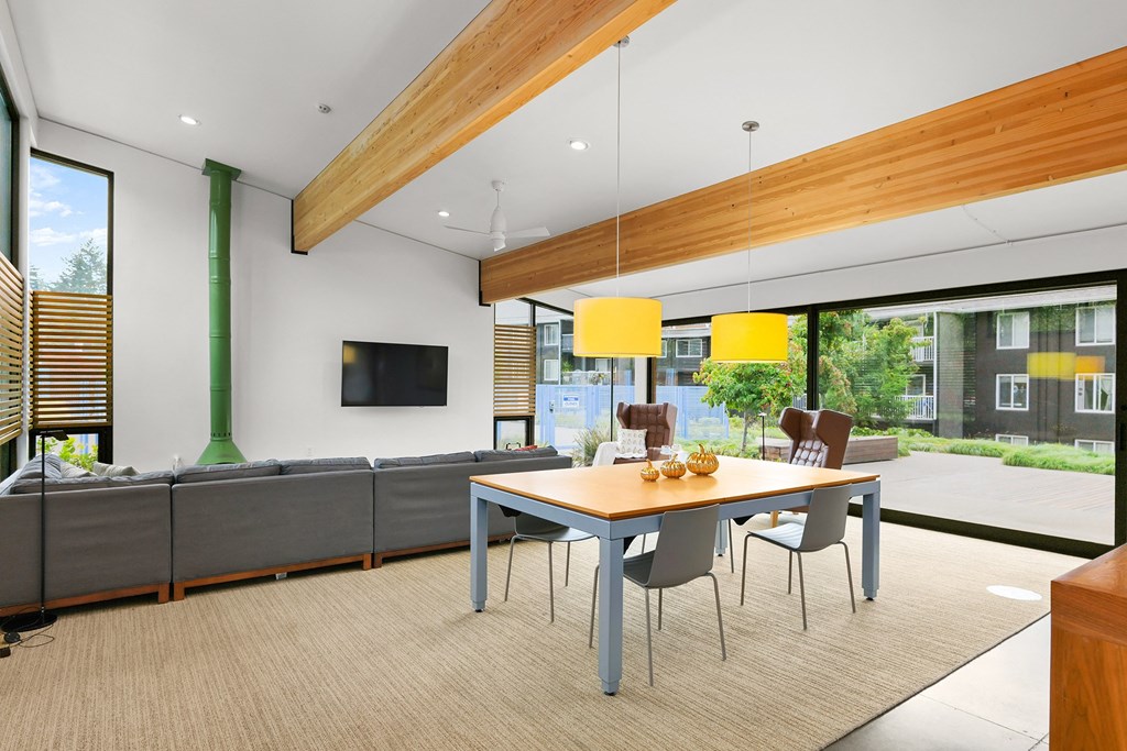 a dining room with a table and chairs and a couch