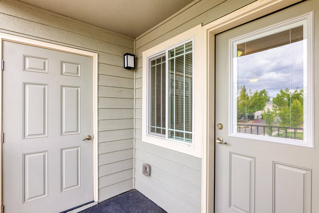 the entrance to a home with a white door and window at Trillium Apartments, Springfield