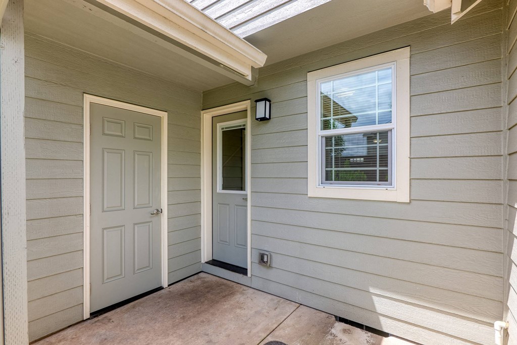 the hallway of the house with a white door and a window at Trillium Apartments, Springfield, OR