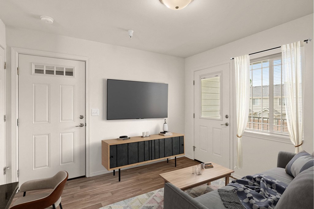 a living room with a couch and a television on the wall at Trillium Apartments, Oregon 97477