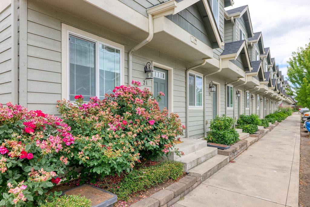 a row of houses with flowers in front of them at Trillium Apartments, Springfield, OR, 97477