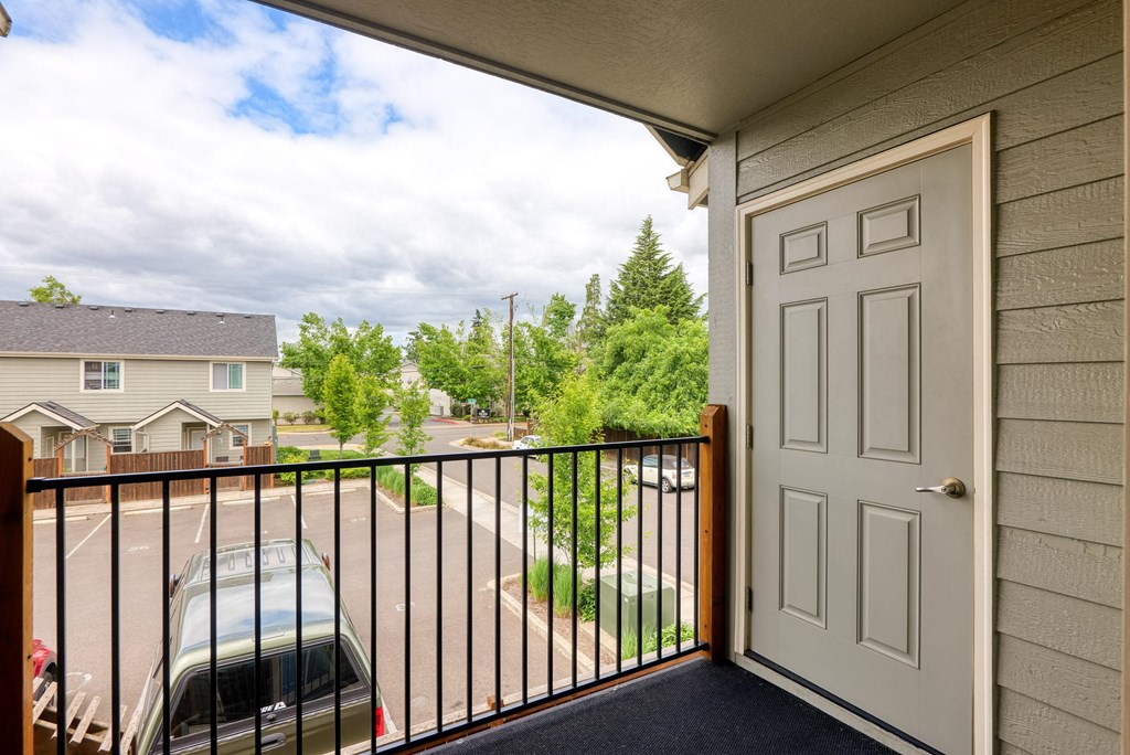 the view from the balcony of a house with a car on the driveway at Trillium Apartments, Oregon