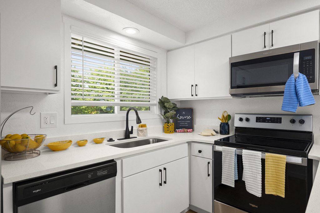 a kitchen with white cabinets and black appliances at Chalet, Springfield, OR, 97477