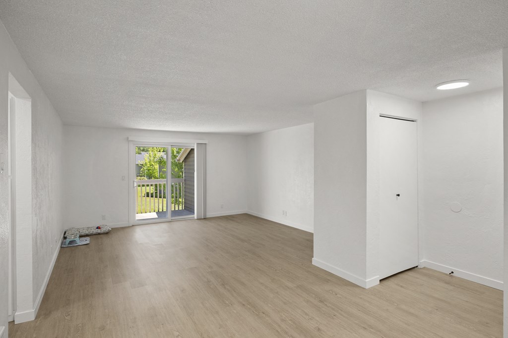 a bedroom with hardwood floors and white walls at Chalet, Springfield, Oregon
