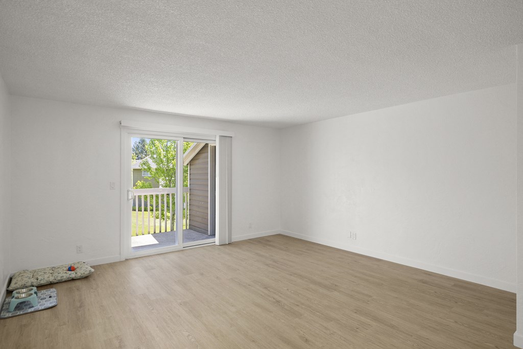 a bedroom with a sliding glass door and hardwood floors at Chalet, Springfield, OR