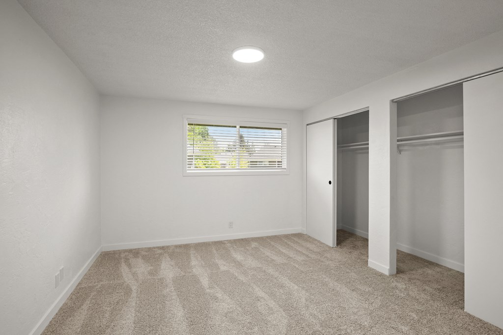 a bedroom with white walls and carpet at Chalet, Springfield, Oregon