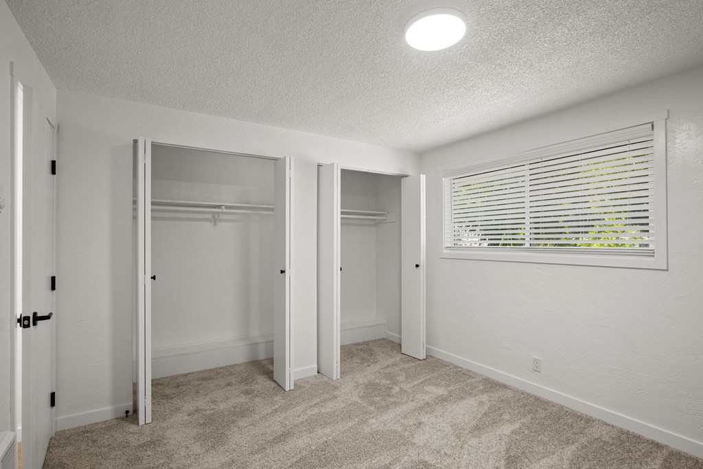 a bedroom with a large window and a closet at Chalet, Springfield, 97477