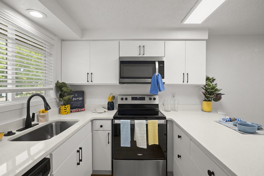 a kitchen with white cabinets and a black and white stove top oven at Chalet, Springfield, OR, 97477