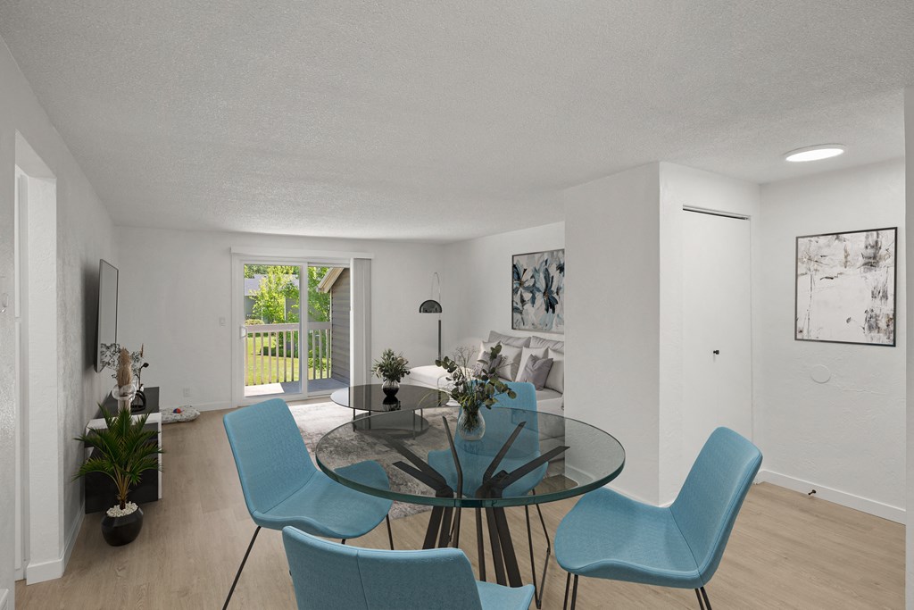 a living room with a glass table and blue chairs at Chalet, Oregon, 97477