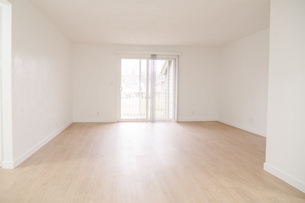 a bedroom with hardwood floors and white walls at Chalet, Springfield, Oregon