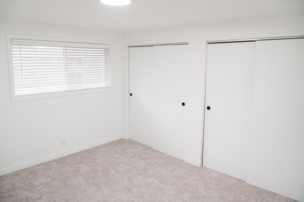 a small bedroom with white walls and carpet at Chalet, Springfield, 97477