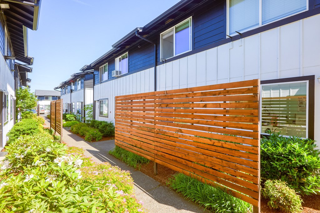 a wooden fence in front of a row of houses