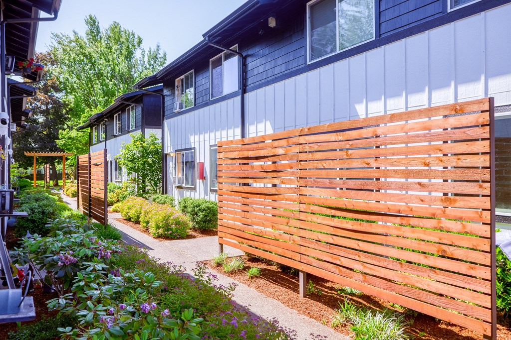 a wooden privacy fence in front of a house