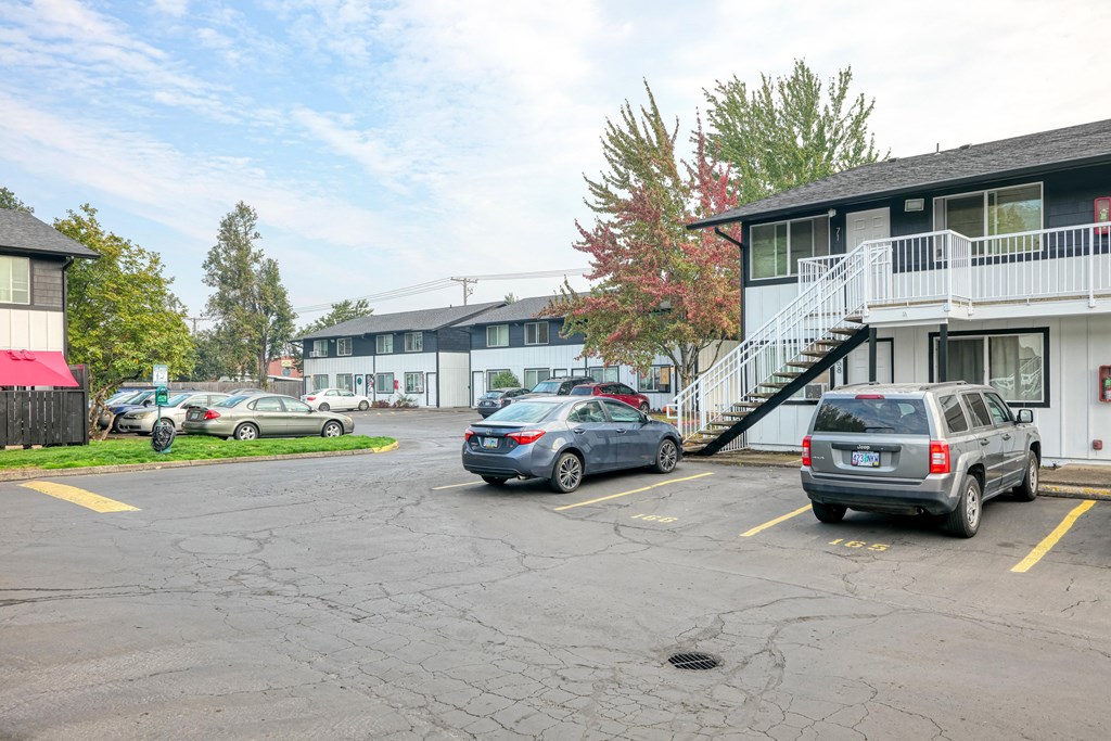 a parking lot with cars in front of a building