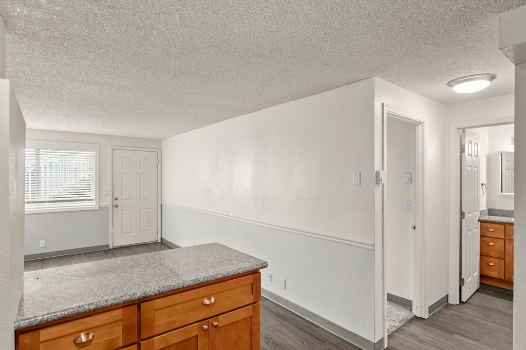 the spacious kitchen with granite countertops and wooden cabinets