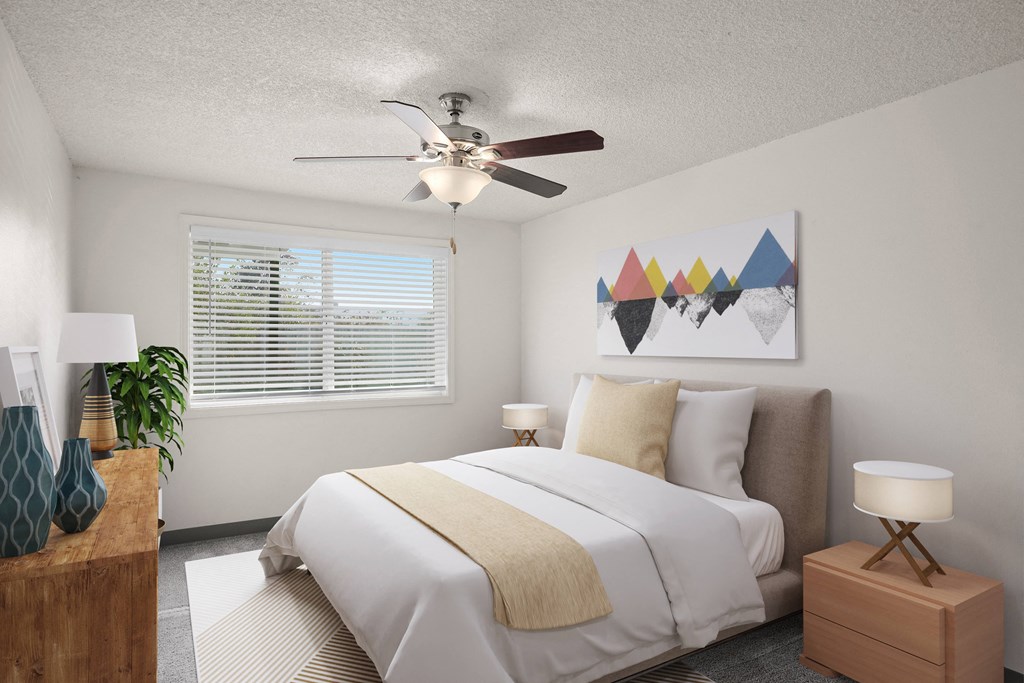 a bedroom with a large bed and a ceiling fan