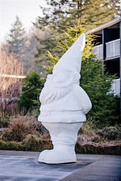 a statue of a gnome in front of a building