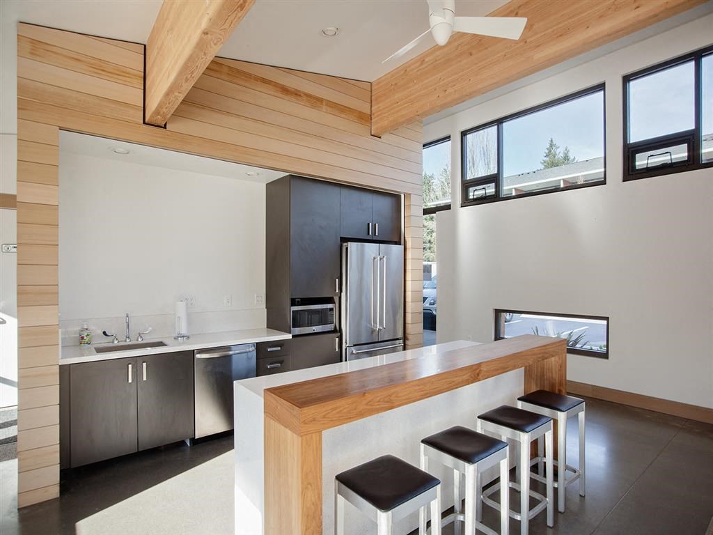 a kitchen with a bar and stools