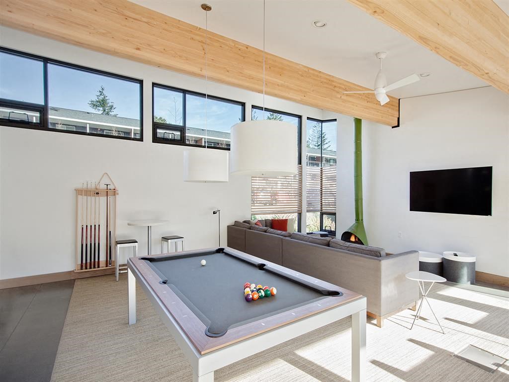 a pool table in the center of a living room