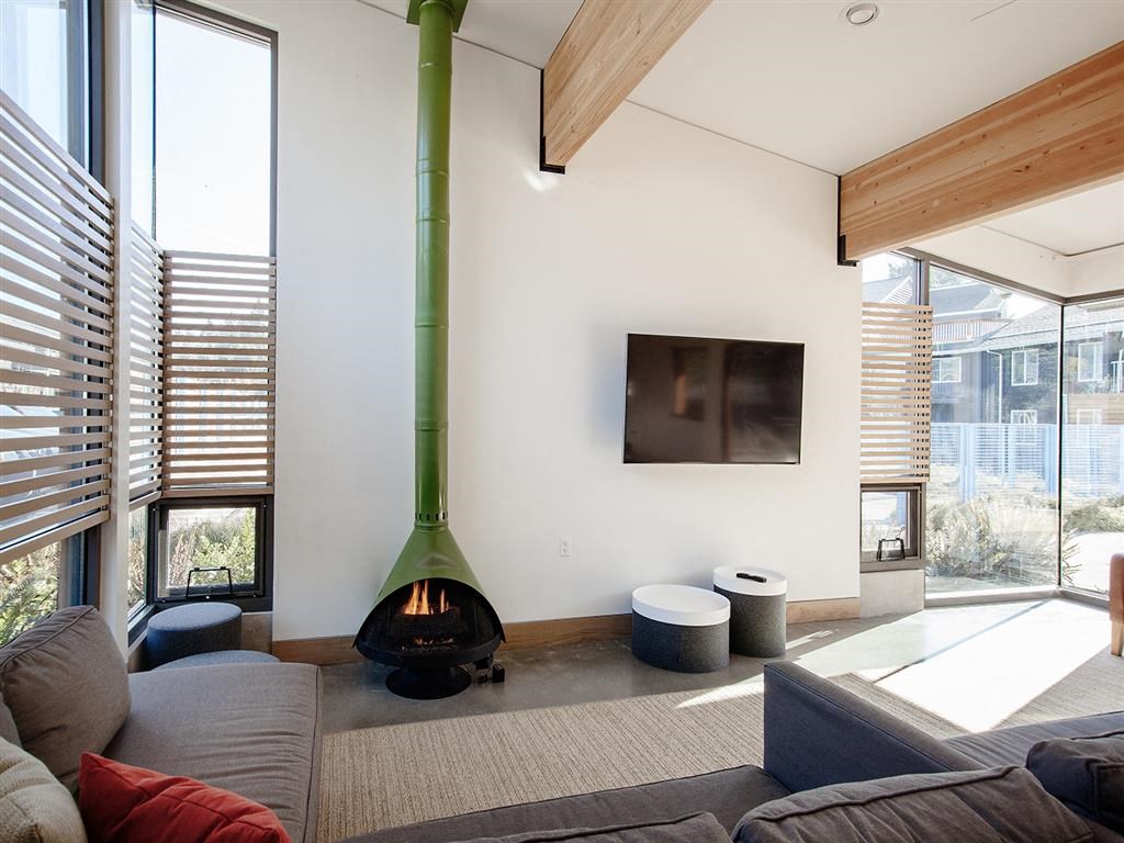 a living room with a fireplace and a green pole