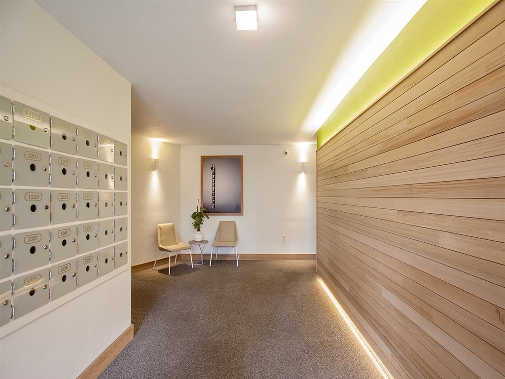 a room with a wall of lockers and a table with chairs