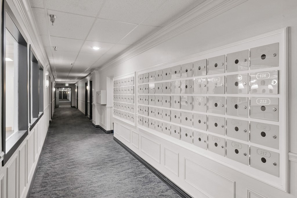 a view of a long hallway with a wall of mailboxes
