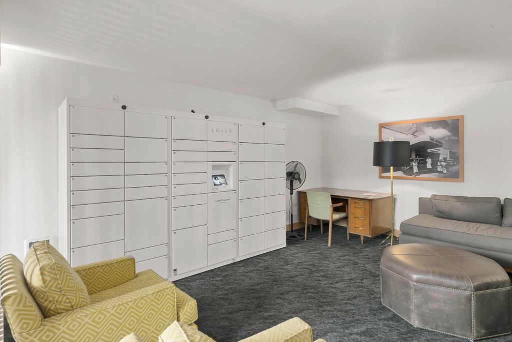 a living room with couches and chairs and a desk