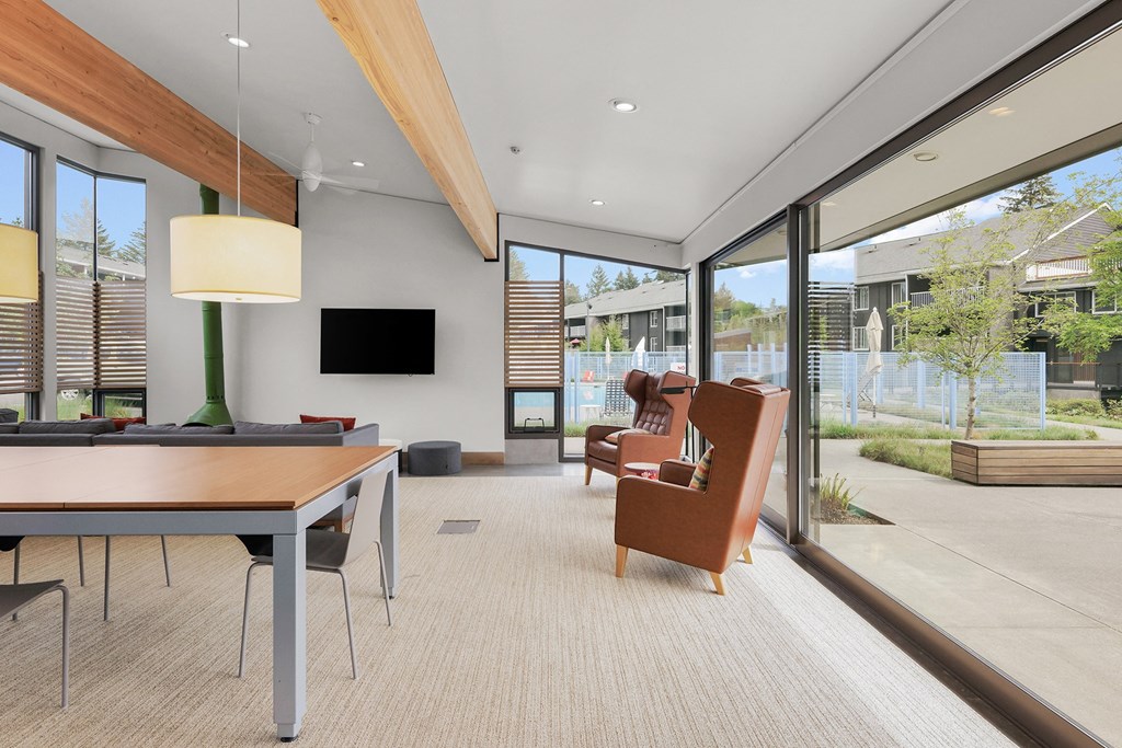 a living room with a table and chairs and sliding glass doors