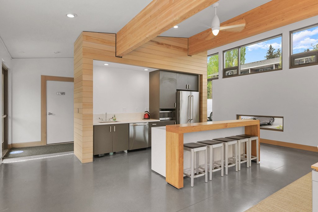 a kitchen with a bar with stools in front of it