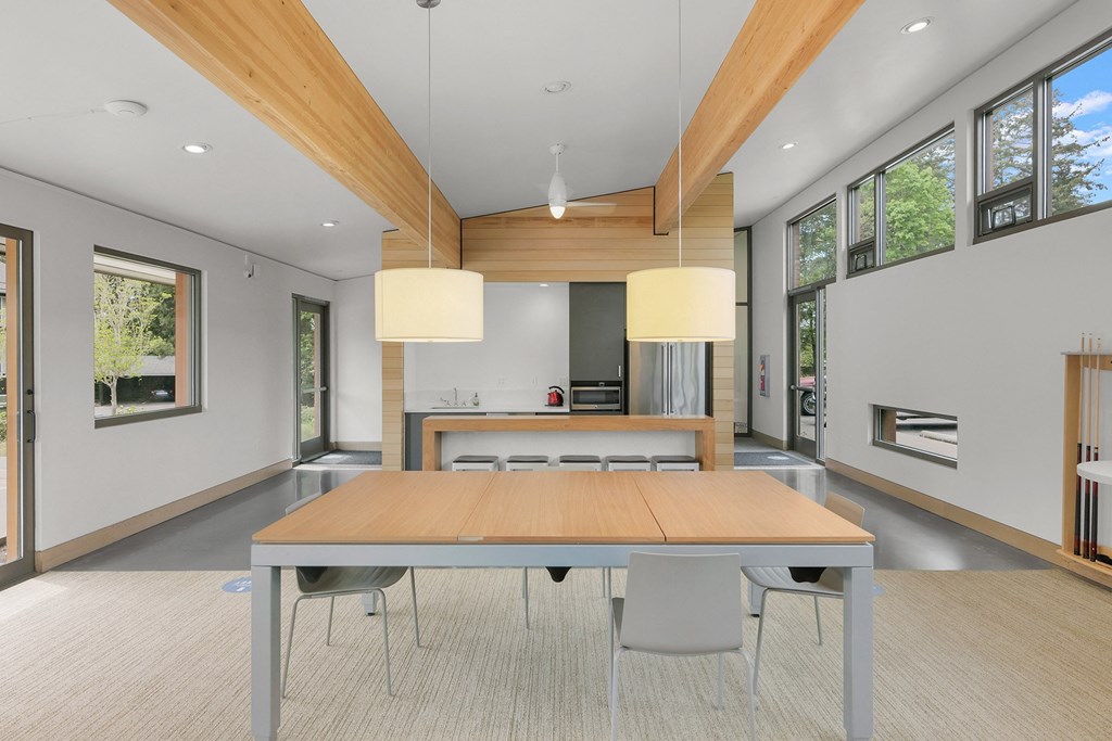 a large dining room with a wooden table and chairs