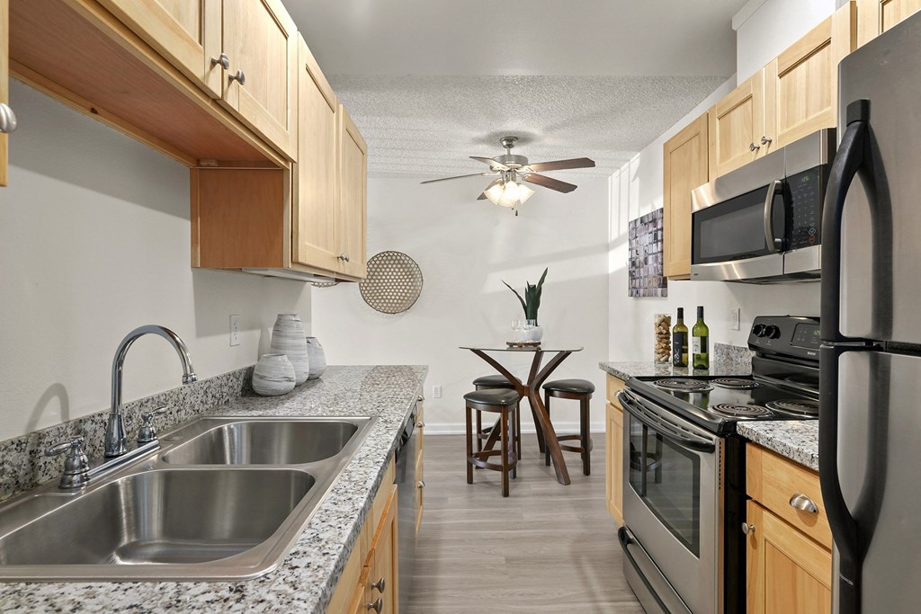 a kitchen with granite counter tops and stainless steel appliances
