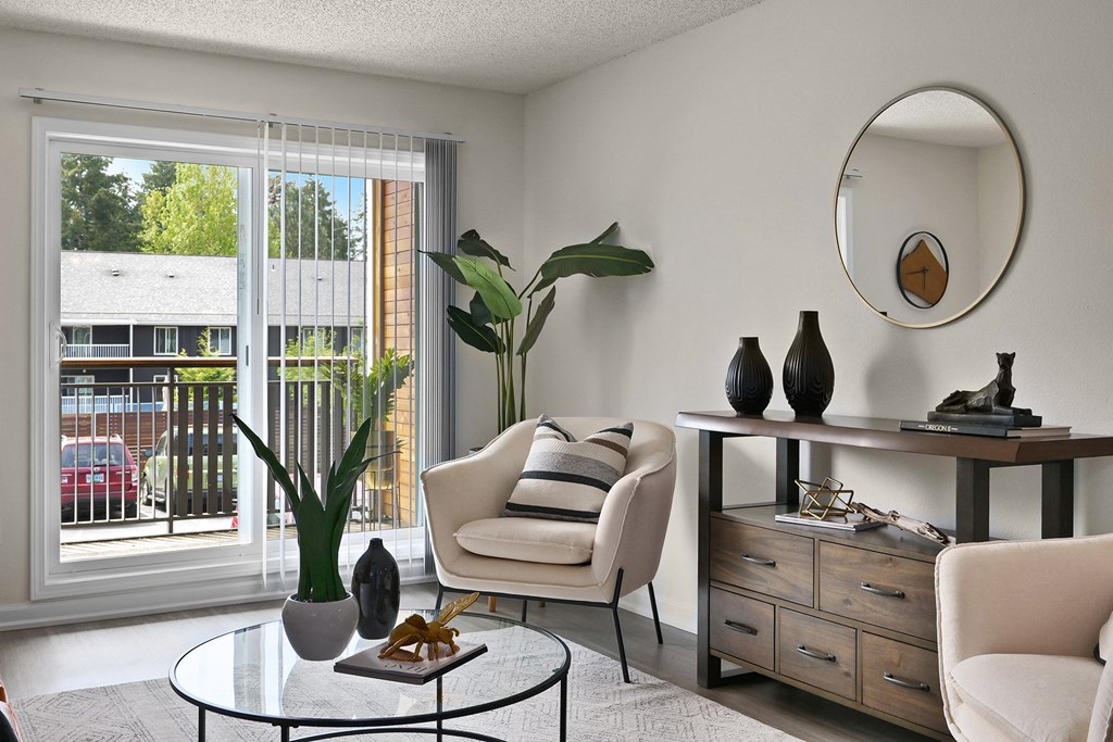 a living room with white furniture and a large window
