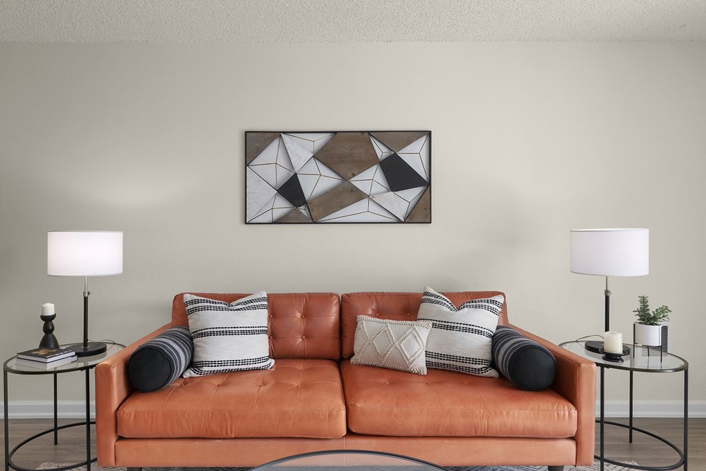 a living room with a brown couch and pillows