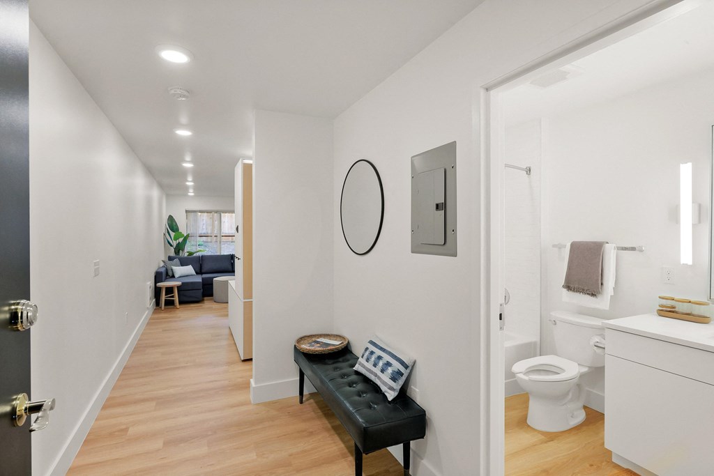 a living room with a couch and a toilet and a bathroom