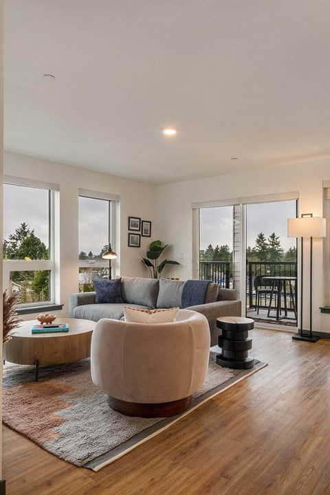 A modern living room with a large sectional sofa and a coffee table.