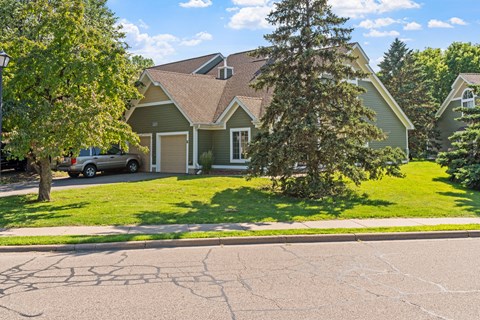 A house with a tree in front of it.