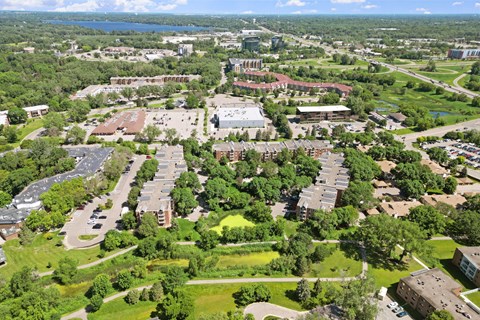 A bird's eye view of a campus with a large building in the center.
