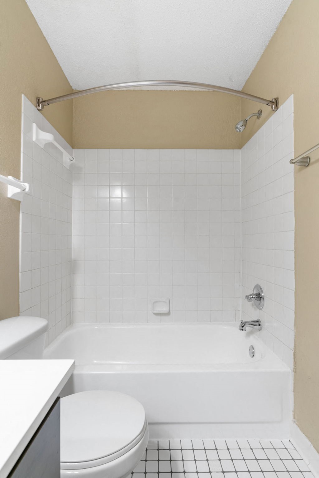 a white bathroom with a toilet and a tub