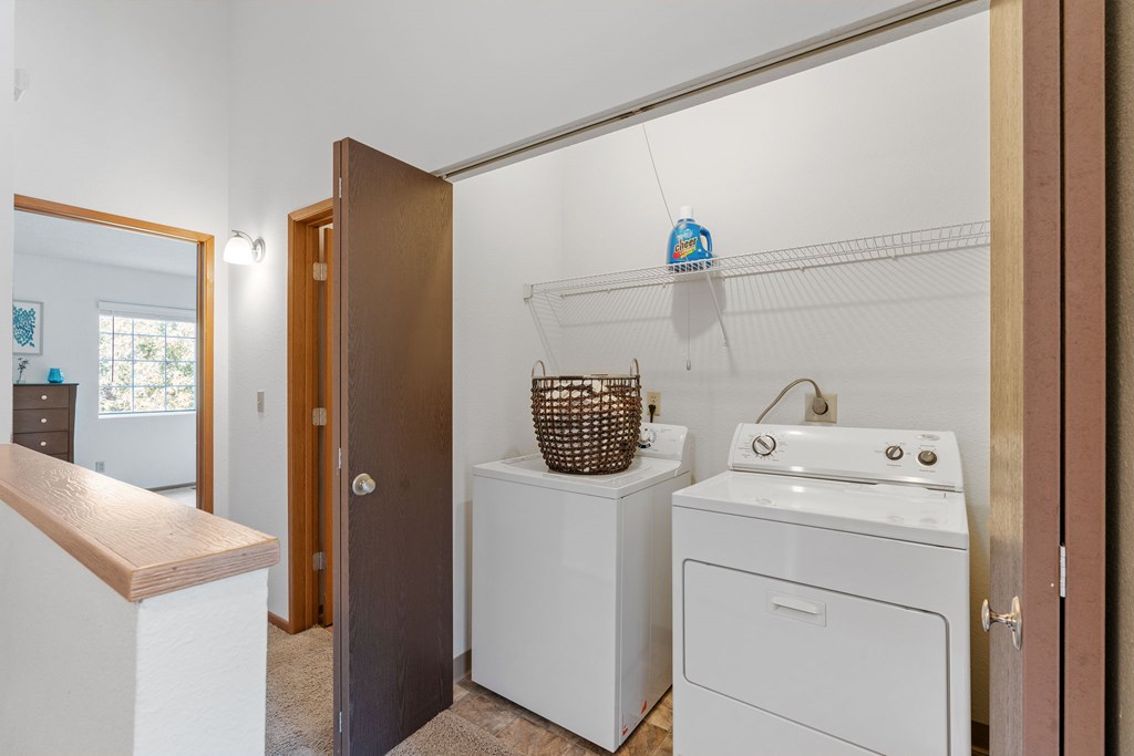 A small laundry room with a washer and dryer.